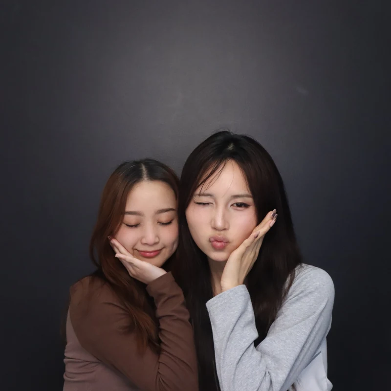 The same friends making a second playful pose